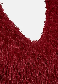 Festtop med fjerlignende materiale